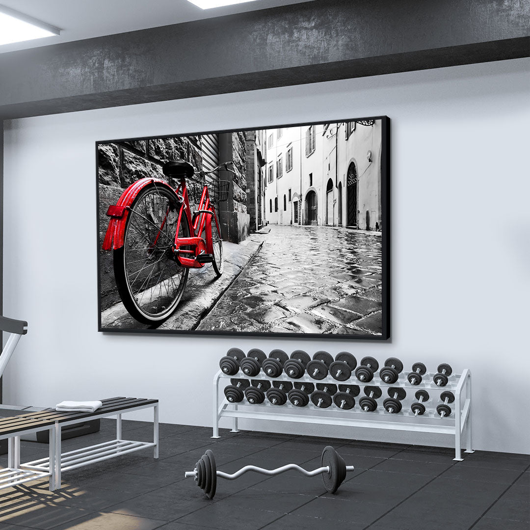 Leinwandbild - Rotes Fahrrad in der Stadt